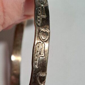 silver bracelet with hearts and boat design